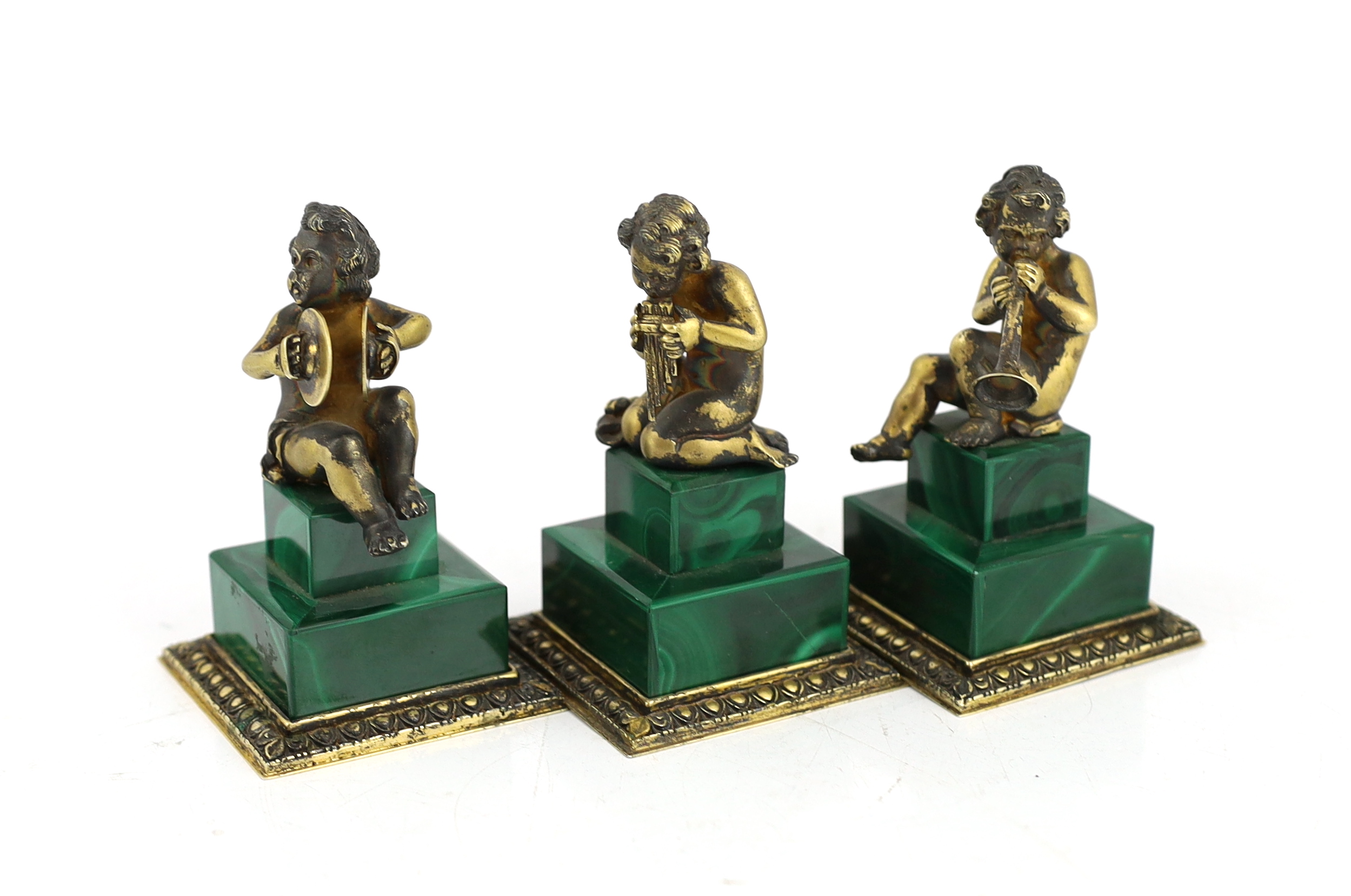 A set of three Italian silver gilt figures of musical putti, 5.5cm wide, 5.5cm deep, 9cm high